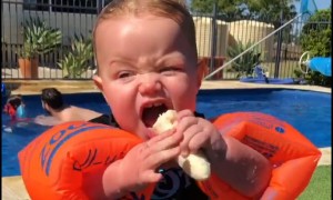Baby's hilarious attempt to eat banana while wearing floaties