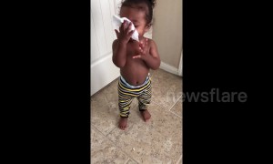 Cute baby imitates someone blowing their nose