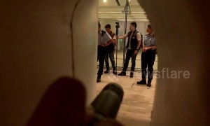 Hong Kong protestors shine flashlights and hurl abuse at police