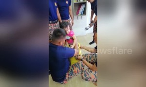 Little girl rescued after getting foot stuck in cooking gas tank in Malaysia