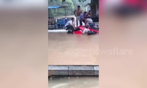 Residents in Chinese town rescue tourists trapped in SUV before it sunk into flooded river