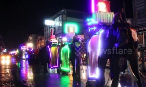 Thai locals celebrate Buddhist Lent with colourful parade that sees elephants wearing luminous attire