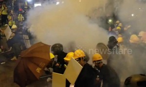 Hong Kong police fire tear gas as protesters approach police lines