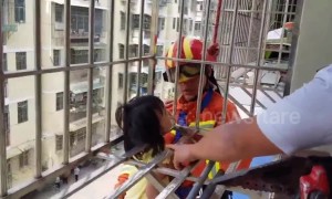 Firefighters rescue girl hanging from fourth-floor window in China's Ganzhou