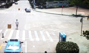 Heroic taxi driver chases down driverless car rolling down road in China and stops it