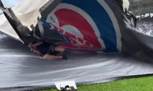 Guy gets caught underneath tarp during Cubs game