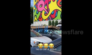 LA man seen precariously taping box to roof of car then driving off