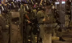 Closeup footage shows Hong Kong riot police firing tear gas towards protesters