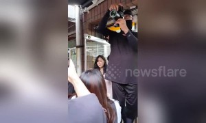 Singer from K-pop group Apink holds impromptu meet-and-greet with fans to boost father's new grocery store