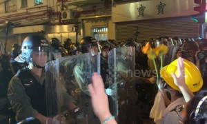 Protesters attempt to give flowers to riot police before attempt to clear streets