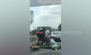 Shocking moment Filipino driver pokes motorcyclist in the eye and knocks him off before speeding away