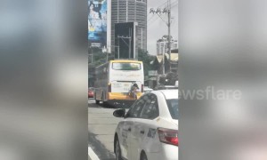 Philippines man dubbed 'Spider-Man' catches free ride on bus