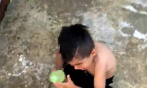 Kid Cowers from Water Balloon