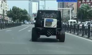 Jeep has air conditioning unit attached to its boot while driving on Chinese road
