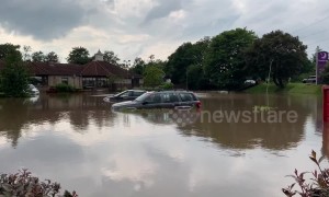 Cars float in water at Grangemouth Premier Inn car park in Scotland amid heavy flooding after severe thunderstorm