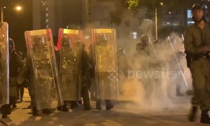 Masked youths in Hong Kong throw bricks and glass bottles at riot police