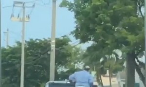 Truck Transports Motorcycle with Man On It