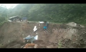 Portacabin and truck fall into river during massive mudslide in China