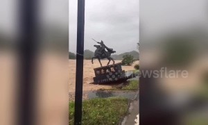 A statue in China is washed away by typhoon Lekima