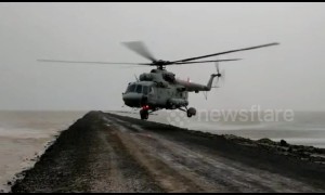 Chopper lands on flood-ravaged highway to rescue 125 people
