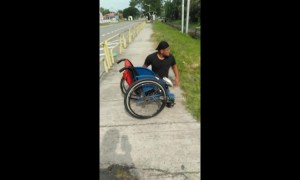 Heartwarming moment disabled man climbs out of wheelchair to save kitten stuck in drain in Malaysia