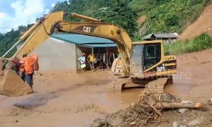 Excavator used to transport people trapped by flooding in Vietnam