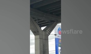 Thai man rants at the top of concrete motorway pillar