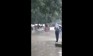 Ingenious way to cross a flooded road