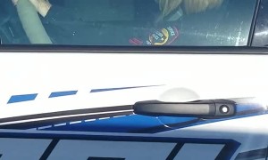 Officer Operates Phone Behind the Wheel