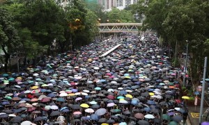 Protesters shout 'Hong Kong People, go for it!' as they march through rain-soaked streets