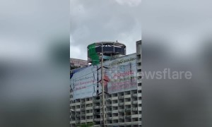 Demolition worker spotted swinging sledgehammer at 12-storey apartment block in Thailand