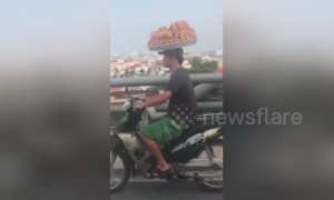 'Basket case biker' spotted on Vietnam highway with bread balancing on his head