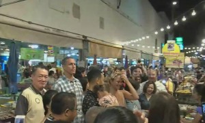 John Legend and Chrissy Teigen walk around Thai street food market