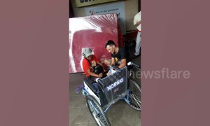 Heartwarming moment tourist gives brand new wheelchair to disabled man begging outside shops