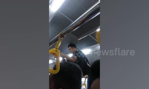 Bus conductor in the Philippines dubbed 'Spider-man' as he climbs over passengers' heads to collect fares