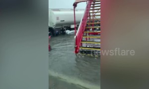 Airport bus drives passengers across flooded tarmac after tropical storm