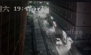 Wind blows over metal fence narrowly missing car driving past in southern China