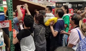 Customers climb under store shutter as China's first Costco shop opens