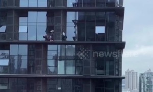 Heroic policemen rescue distressed woman from window ledge