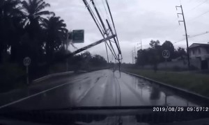 Terrifying moment electricity pylons are blown onto car during Thai storm