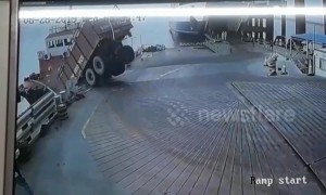 Shocking moment dump truck in India topples over into ocean