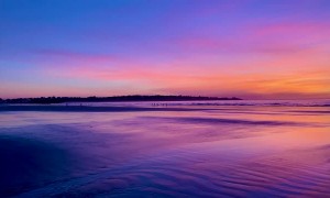 Spectacular Sunrise Reflects off Wet Sand