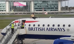 Man Sits on top of Plane at London City Airport