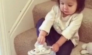 Responsible toddler gets ready to go out all by herself