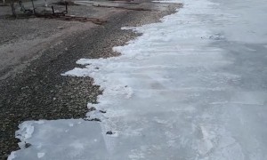 Creeping Ice Washes onto Shoreline