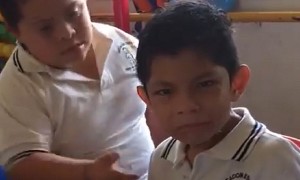 Boy With Down Syndrome Hugs And Comforts An Autistic Classmate
