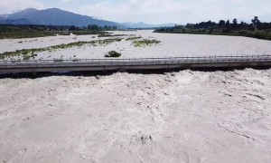 Flooded River Rises To Bridge's Roadway