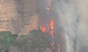 Fire in Australia filmed hugging cliffside like 'lava waterfall'