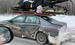 Cheap Car Carries Expensive Snowmobile