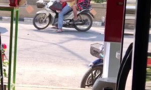 Person Playing with a Puppy on a Scooter